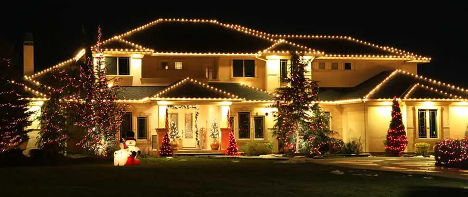 Home with Christmas lights and lawn decorations in Fishers, IN.