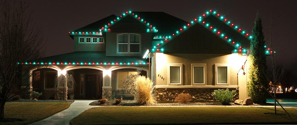Home in Fishers, IN with red and green Christmas lighting.