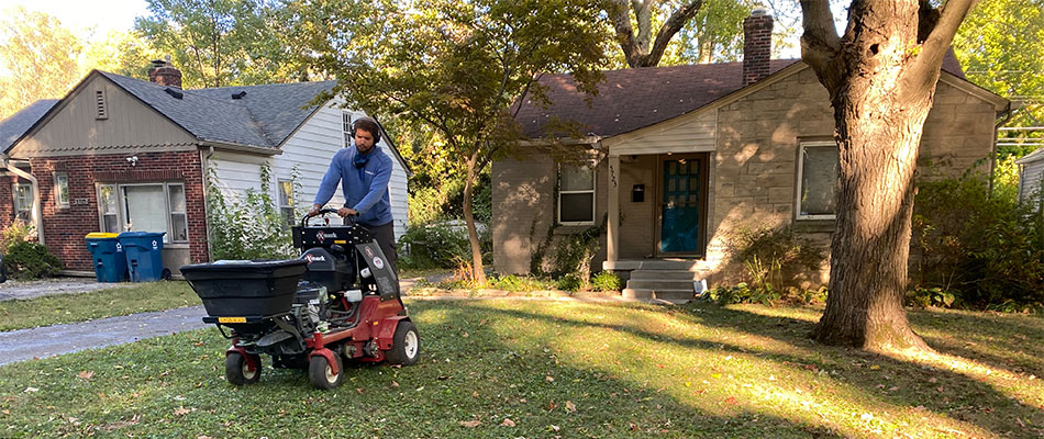 Lawn care worker using core aeration equipment in Carmel, IN.